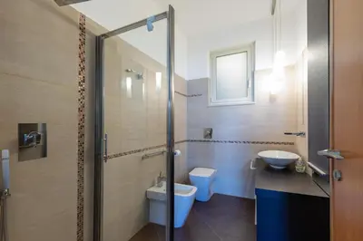 a bathroom with a shower and a toilet and a sink at Visitsicilia Sabbia Dorata in Alcamo Marina