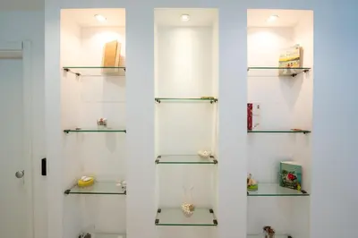 a white wall with glass shelves in a room at Palermo Central BB in Palermo