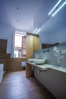 a bathroom with a tub and a sink and a toilet at Aromatika Suite in Palermo