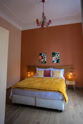 a bedroom with a bed and a desk in a room at Aromatika Suite in Palermo