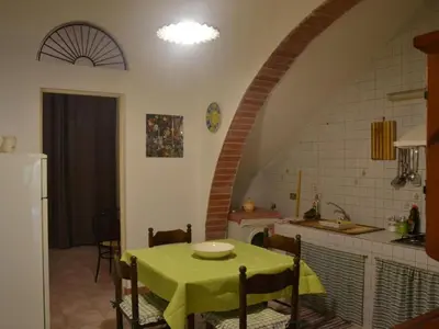 a kitchen with a table with a green table cloth at Apartment Wohnung mit Wasserblick by Interhome in Castellammare del Golfo