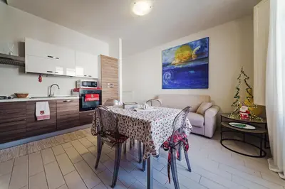 a kitchen with wooden cabinets and a sink and a stove at Hybrid Icon Rooms Gallery City Center in Palermo