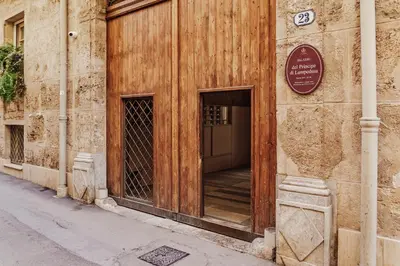 an empty courtyard with a large white building at Hybrid Icon Rooms Gallery City Center in Palermo