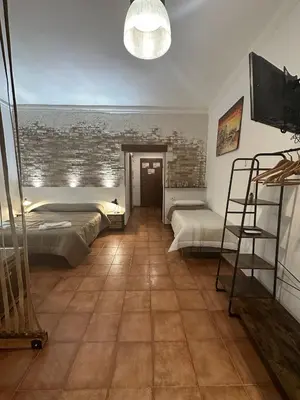 a kitchen with a counter with a sink and a stove at Loft Materassai in Palermo