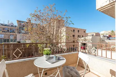 a balcony with a table and chairs on a balcony at Ludohome in Palermo