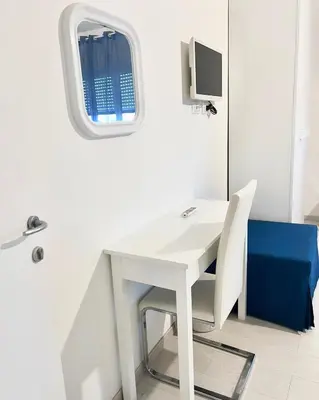 a white desk in a room with a window at Aurea Suites in Palermo