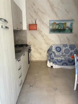a kitchen with a stove and a counter top at Casita Blanca in Santa Flavia
