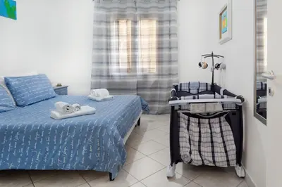 a bedroom with a bed and a cart with towels on it at Zagarellai apartment alla Kalsa Fast wi-fi in Palermo