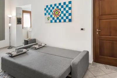 a bed with two pillows on it in a room at Zagarellai apartment alla Kalsa Fast wi-fi in Palermo