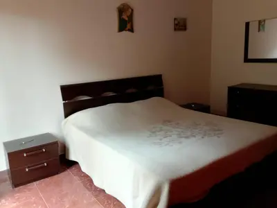 a bedroom with a bed with a white comforter at Altofonte Vista in Altofonte