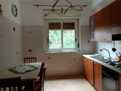 a kitchen with a table and a window at Altofonte Vista in Altofonte
