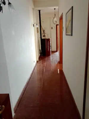 a hallway with white walls and a tile floor at Altofonte Vista in Altofonte