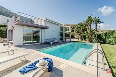 a swimming pool in the backyard of a house at Villa Privata con Piscina a Scopello in Castellammare del Golfo