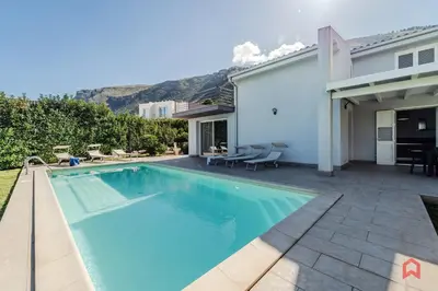 a swimming pool in the backyard of a house at Villa Privata con Piscina a Scopello in Castellammare del Golfo