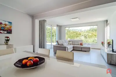 a living room with a table with a bowl of fruit on it at Villa Privata con Piscina a Scopello in Castellammare del Golfo