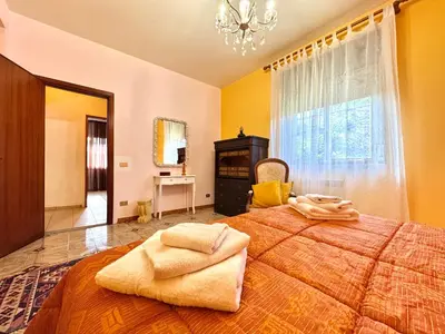 a bedroom with a large bed and a window at O Firrìu in Carini