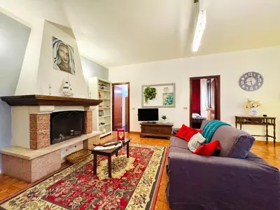 a living room with a couch and a fireplace at O Firrìu in Carini