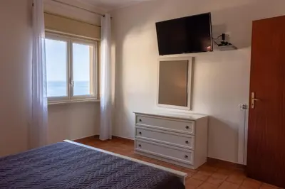 a bedroom with a bed and a television on a wall at casavacanzabordonaro in Palermo