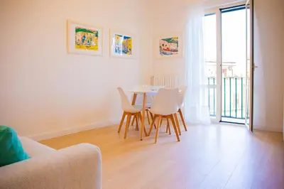 a dining room with a table and white chairs at Solemar Sicilia - Vista Mare Alla Cala in Palermo