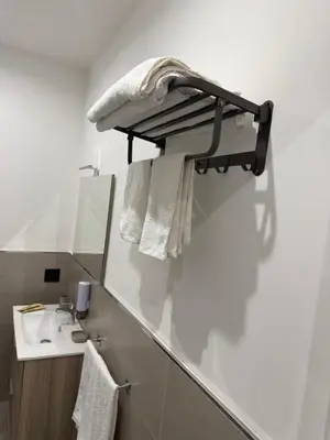a bathroom with a sink and a mirror and towels at Casa Leo in Palermo