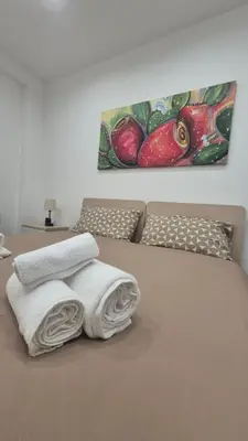 a bedroom with a bed with two towels on it at Casa Leo in Palermo