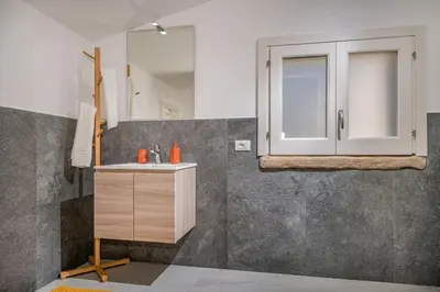 a bathroom with a sink and a mirror at Villa Coraline - Castellammare in Balata di Baida