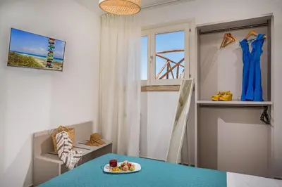 a dining room with a blue table and a window at Villa Coraline - Castellammare in Balata di Baida