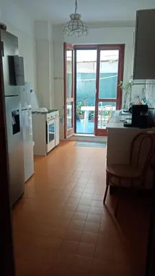 a kitchen with a refrigerator and a table with a view at Rocca Appartament Palermo Beach in Palermo