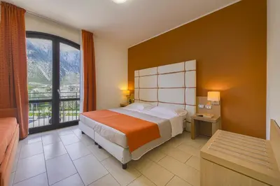 a lobby with a counter and chairs in a room at Al ritrovo in Castelluzzo