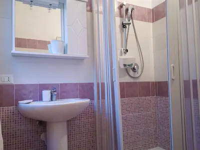 a bathroom with a sink and a shower at Casaulente Mare in Alcamo Marina