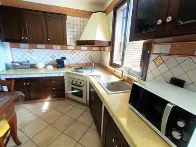 a kitchen with a sink and a microwave at Casa La Plaza in Balestrate