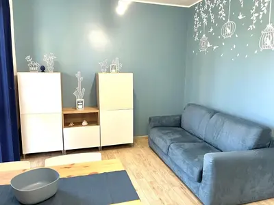a living room with a blue couch in a room at Casa Roccella in Buonfornello