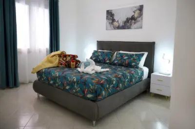 a bed with two stuffed animals on it in a bedroom at L'arco Sul Mare in Balestrate