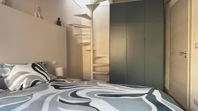 a bedroom with a bed and a book shelf at Casa NiMia al centro storico di Palermo in Palermo
