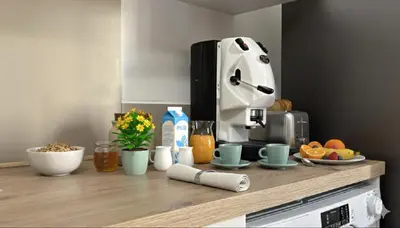 a kitchen counter with a coffee maker on top of it at Casa NiMia al centro storico di Palermo in Palermo