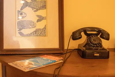 a telephone sitting on a table next to a picture at GaR07 in Castellammare del Golfo