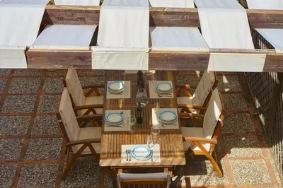 an overhead view of a table and chairs with plates at Villa Rubea - 100 meters from the sea in Scopello