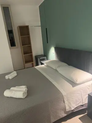 a bedroom with a bed with two towels on it at Luxury Rooms Soraja in Palermo