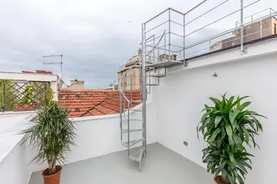 a staircase on a white building with two plants at Mori apartment Libertà Politeama in Palermo