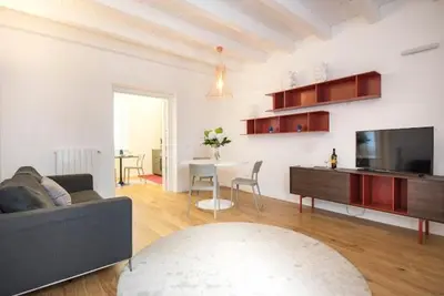 a living room with a couch and a table with a tv at Mori apartment Libertà Politeama in Palermo