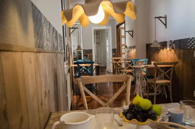 a dining room with a table with a bowl of fruit at Guelio al Massimo Suites&Breakfast in Palermo