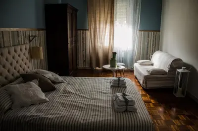 a living room with a bed and a couch at Guelio al Massimo Suites&Breakfast in Palermo