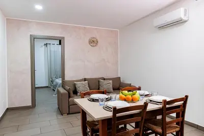a living room with a table and a couch at Meschita Little House in Palermo