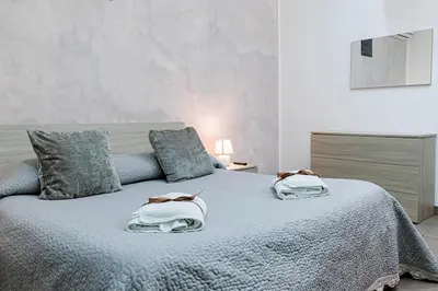 a bedroom with a bed with two pillows on it at Meschita Little House in Palermo