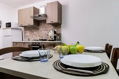 a kitchen with a table with plates and glasses at Meschita Little House in Palermo