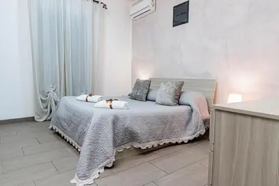 a bedroom with a bed with two pillows on it at Meschita Little House in Palermo