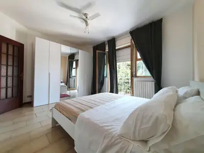 a bedroom with a white bed with a ceiling fan at Apartment Happy House by Interhome in Palermo
