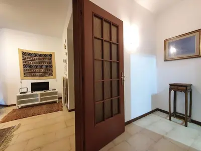 a door leading into a room with a television at Apartment Happy House by Interhome in Palermo