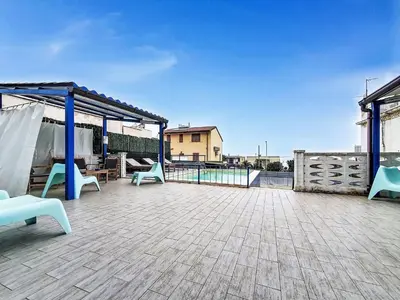 a playground with a toy house and a slide at Villa Blu Corallo by Interhome in Alcamo Marina