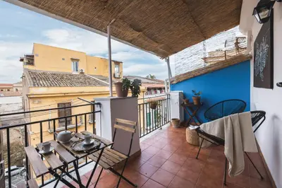 a room with a balcony with a table and chairs at Cala & Cassari View By DomuSicily in Palermo